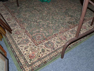 Lot 1151 - A modern green Persian style floral carpet with cream border