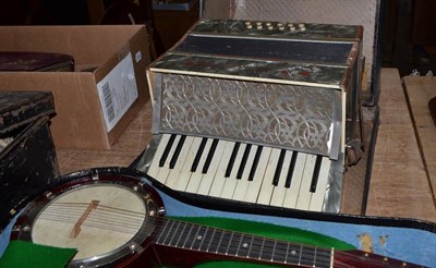 Lot 1159 - A British made ";Banjolele"; cased and a cased accordion