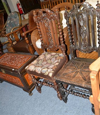 Lot 1215 - Two similar carved oak dining chairs and a carved camphor wood chest