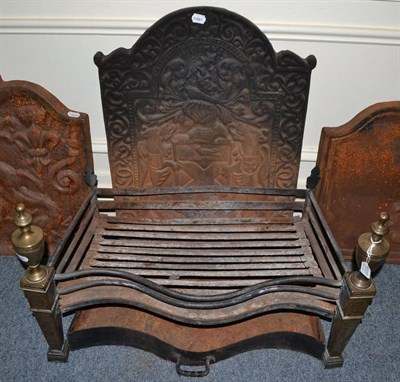 Lot 1227 - A cast iron fire back and a fire grate with brass mounts to the front