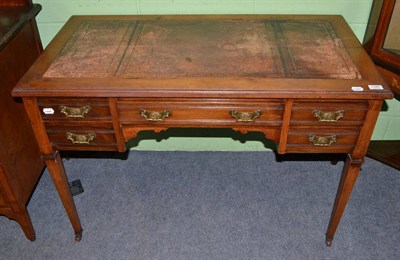 Lot 1347 - A late Victorian oak writing table with leather top