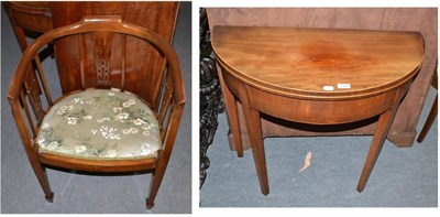 Lot 1380 - An Edwardian mahogany bow armchair and a 19th century mahogany D-end fold-over tea table