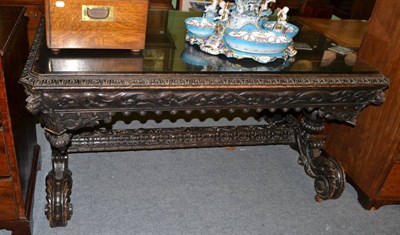 Lot 1381 - A large 19th century ebonised carved oak table on stretcher base