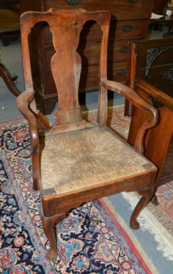 Lot 1387 - An early 19th century rush seated oak open armchair