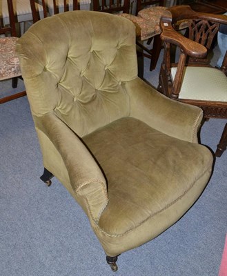 Lot 1393 - A late Victorian green velvet upholstered armchair with ebonised legs