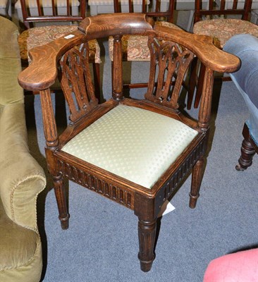 Lot 1394 - A late 19th century carved oak corner chair