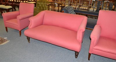 Lot 1396 - A Victorian two seater sofa and two similar armchairs, all upholstered in pink