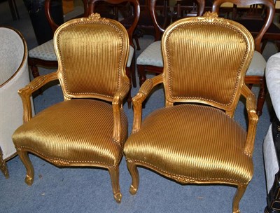 Lot 1399 - A pair of yellow upholstered reproduction gilt armchairs