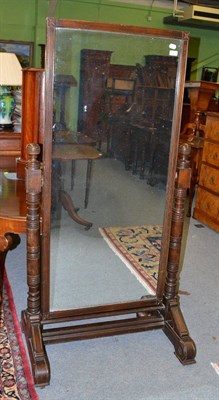 Lot 1409 - A large carved oak cheval mirror