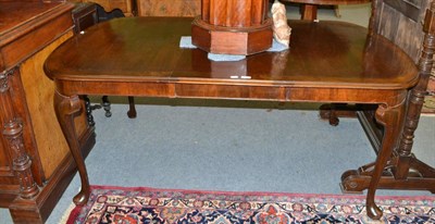 Lot 1410 - A mahogany dining table with spare leaf and four brass fittings