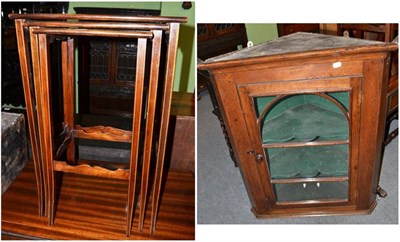 Lot 1438 - A nest of tables and an oak corner cupboard