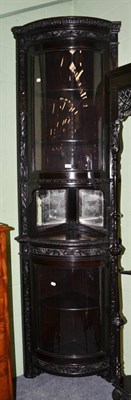 Lot 1452 - A tall late Victorian carved and ebonised standing corner cabinet with glazed front