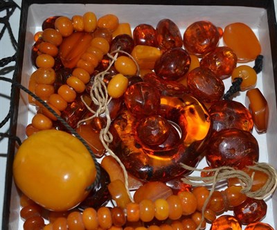 Lot 11 - A quantity of amber jewellery, including a yellow nugget on cord necklace, a necklace of mixed...