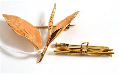 Lot 23 - A bow brooch, stamped '14k' and a foliate brooch (2)