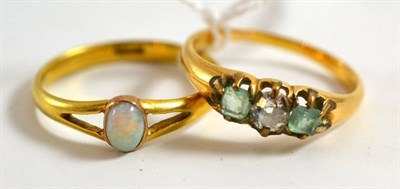 Lot 52 - A diamond and emerald three stone ring and an opal ring, stamped '18CT'