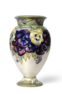 Lot 572 - William Moorcroft (British, 1872-1945): A Pansy Pattern Pedestal Vase, circa 1913-16, in...