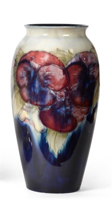 Lot 573 - William Moorcroft (British, 1872-1945): A Pansy Pattern Vase, on a blue wash and deep blue...