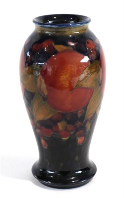 Lot 575 - William Moorcroft (British, 1872-1945): A Pomegranate Pattern Baluster Vase, on a blue ground,...