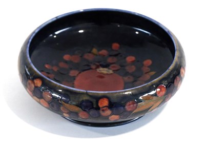 Lot 576 - William Moorcroft (British, 1872-1945): A Pomegranate Pattern Bowl, on a blue ground, impressed...