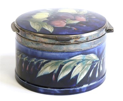 Lot 577 - William Moorcroft (British, 1872-1945): A Wisteria Pattern Circular Hinged Trinket Box, with...