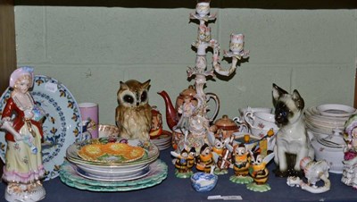 Lot 136 - A shelf of decorative ceramics including a German figural candelabrum, a Delft plate, a...