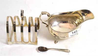 Lot 145 - A silver cream jug, toast rack and mustard spoon