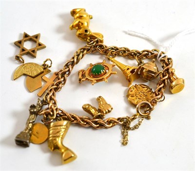 Lot 193 - A charm bracelet, two loose charms, a cross and a Mizpah coin