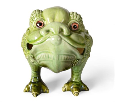 Lot 599 - A Burmantofts Faience Pottery Grotesque Toad, modelled on three legs with glass eyes, green...