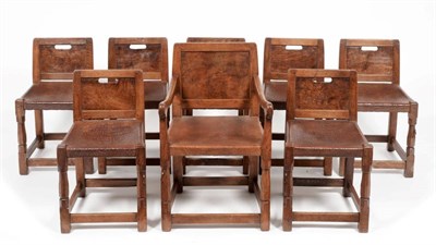 Lot 643 - Mouseman: A Set of Eight (7+1) 1930s Robert Thompson Panel Back Dining Chairs, with aperture to...