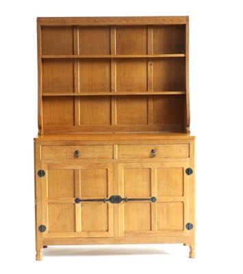 Lot 668 - Mouseman: A Robert Thompson 4ft English Oak Welsh Dresser, the open delft rack with two fixed...