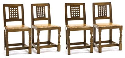 Lot 681 - Mouseman: Four Robert Thompson English Oak Lattice Back Dining Chairs, with tan cow hide...