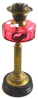 Lot 56 - A Victorian oil lamp with a cranberry reservoir