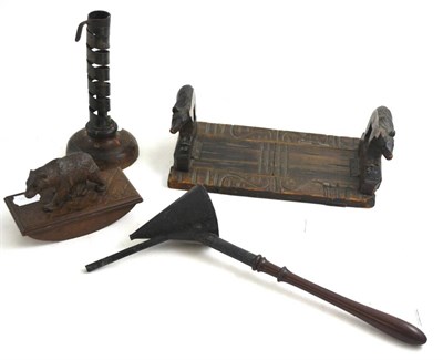 Lot 71 - A ";rats tail"; candlestick, Black Forest book rack, blotter and a candle snuffer