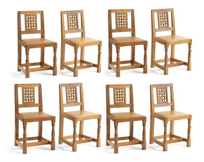 Lot 690 - Mouseman: A Set of Eight Robert Thompson English Oak Lattice Back Dining Chairs, with tan cow...