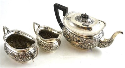 Lot 201 - Embossed silver three piece tea service