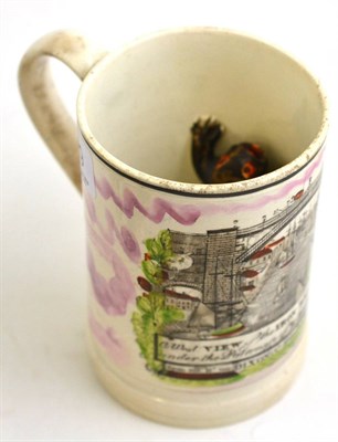 Lot 229 - A 19th century English creamware frog mug, 13cm high