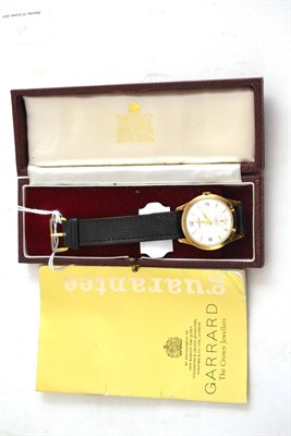 Lot 246 - A 9ct gold gents wristwatch, retailed by Garrard, with Garrard box and booklet