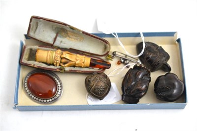 Lot 259 - A Meerschaum and amber pipe, three carved netsukes and mask pendant, Scottish thistle brooch...