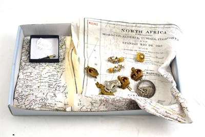 Lot 264 - A quantity of military badges etc and two linen maps