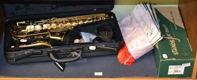 Lot 333 - A Yamaha Alto sax, model Yas275, cased, with saxophone stand and music Grade 3 books