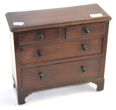 Lot 416 - A mahogany miniature chest of drawers