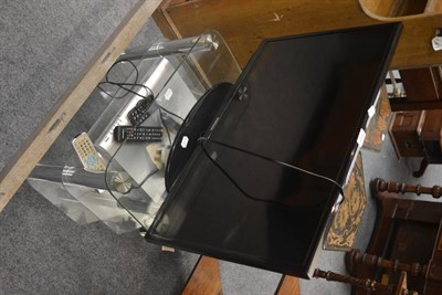 Lot 533 - Samsung flat screen television, Bush DVD player on a modern glass TV stand