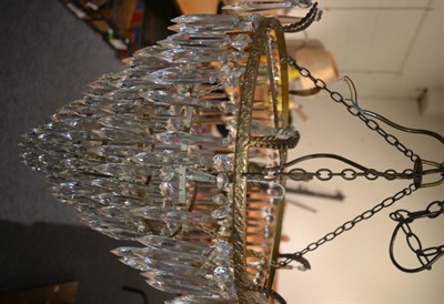 Lot 619 - A gilt metal chandelier with glass drops