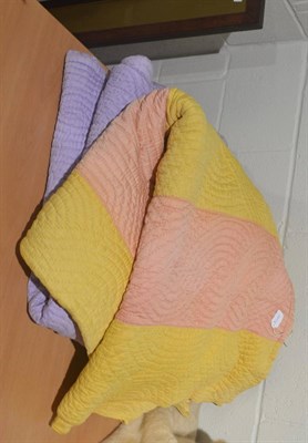 Lot 631 - Yellow and peach striped reversible Durham quilt and another in purple and pink