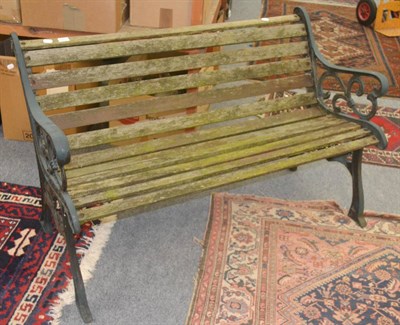 Lot 647 - Modern garden bench with cast iron ends