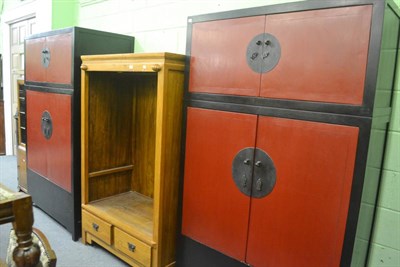 Lot 677 - A pair of Chinese ebonised and red painted wardrobes, 120cm wide and a Chinese hardwood...