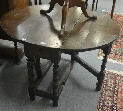 Lot 681 - Two 18th century oak gateleg dining tables and an oak bookcase