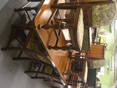 Lot 685 - A circa 1920's carved oak draw leaf refectory type table and six oak framed dining chairs with...