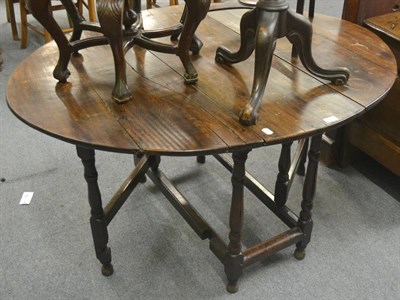 Lot 695 - An early 18th century oak gateleg table on spindle turned legs