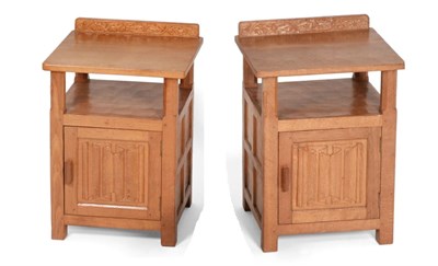 Lot 745 - Lizardman: A Pair of Derek Slater Panelled English Oak Bedside Cupboards, the raised upstand carved